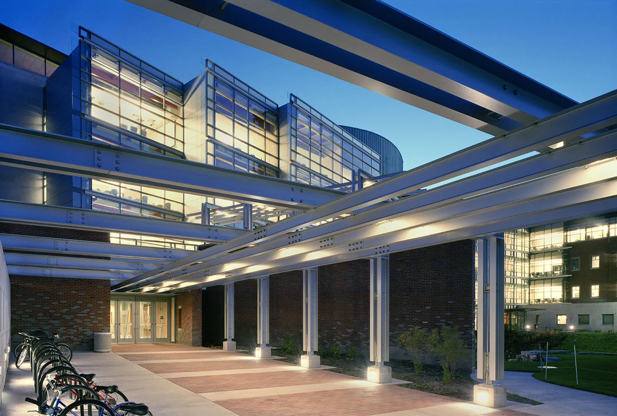 The glass-fronted computer science building at Illinois, with illuminated walkways and a blue evening sky.